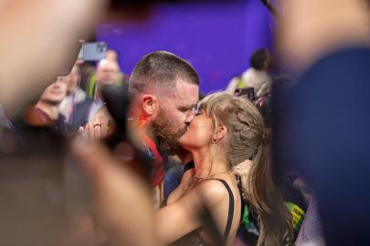 Travis Kelce Packs on the PDA With Taylor Swift at Mahomes Charity Auction